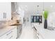 Bright, modern kitchen with stainless steel appliances, sleek white cabinets, and island with breakfast bar at 716 S Lois Ave, Tampa, FL 33609
