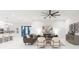 Bright living room features modern decor, ceiling fan, marble flooring, and an open view of the modern kitchen at 716 S Lois Ave, Tampa, FL 33609