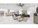 Sun-filled living room features a ceiling fan, modern sofas, marble floors, and an open layout to the kitchen at 716 S Lois Ave, Tampa, FL 33609