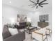 Spacious living room boasts modern decor, a large ceiling fan, and connects seamlessly to the rest of the home at 716 S Lois Ave, Tampa, FL 33609