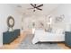 Sunlit main bedroom features modern decor, a ceiling fan, and wood floors at 716 S Lois Ave, Tampa, FL 33609