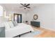 Airy main bedroom features white walls, ceiling fan, and patio access at 716 S Lois Ave, Tampa, FL 33609