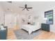 Inviting main bedroom is illuminated by natural light and features hardwood floors and a ceiling fan at 716 S Lois Ave, Tampa, FL 33609