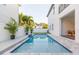 Relaxing pool area with a well-maintained lawn, elegant landscaping, and outdoor dining at 716 S Lois Ave, Tampa, FL 33609