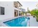 Inviting pool area with an outdoor kitchen, modern outdoor seating, and a bright, refreshing ambiance at 716 S Lois Ave, Tampa, FL 33609