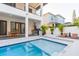 Stunning pool area featuring an outdoor kitchen, comfortable lounge chairs, and a serene atmosphere at 716 S Lois Ave, Tampa, FL 33609