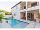 Beautiful pool with stylish landscaping, covered outdoor dining, and a modern aesthetic at 716 S Lois Ave, Tampa, FL 33609