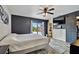 Modern main bedroom featuring a sliding barn door, ceiling fan and slider to back yard at 7405 41St Ave N, St Petersburg, FL 33709