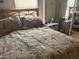 Cozy bedroom featuring a queen bed with tropical-themed bedding and a mirrored closet at 12501 Ulmerton Rd # 140, Largo, FL 33774