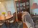 Dining area boasts a wood table, chairs, and a china cabinet for storage and display at 12501 Ulmerton Rd # 140, Largo, FL 33774