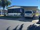Charming home with a carport, mature landscaping, and well-maintained lawn at 12501 Ulmerton Rd # 140, Largo, FL 33774