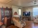 Inviting living room with wood floors, ceiling fan, and a large display cabinet at 12501 Ulmerton Rd # 140, Largo, FL 33774