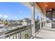 Balcony view with railings, showing neighborhood homes, palm trees, and a spiral staircase at 18077 3Rd St, Redington Shores, FL 33708