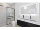 Modern bathroom featuring a frameless glass shower and backlit vanity mirror at 18077 3Rd St, Redington Shores, FL 33708
