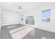 Bright bedroom with a balcony, tile floors, white walls, and a ceiling fan at 18077 3Rd St, Redington Shores, FL 33708