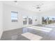 Sun-filled bedroom featuring tile floors, white walls, and balcony access with views at 18077 3Rd St, Redington Shores, FL 33708