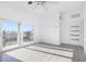 Bedroom featuring gray floors, white walls, sliding glass doors to the balcony, and an open doorway at 18077 3Rd St, Redington Shores, FL 33708