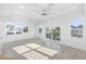 Open bedroom with sleek floors, balcony access, recessed lighting, and plenty of natural light at 18077 3Rd St, Redington Shores, FL 33708