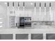 Spacious kitchen featuring an island with white countertops, stainless steel appliances, and custom lighting at 18077 3Rd St, Redington Shores, FL 33708