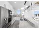 Modern kitchen featuring a large island with cooktop, white cabinetry, and stainless appliances at 18077 3Rd St, Redington Shores, FL 33708