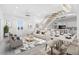 Bright, open-concept living space with modern furnishings and staircase to the upper level at 18077 3Rd St, Redington Shores, FL 33708