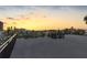 Sunset views from a rooftop deck with a black railing and stairs at 18077 3Rd St, Redington Shores, FL 33708