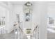 Bright modern staircase featuring cable railing, pendant lighting, and natural light at 18077 3Rd St, Redington Shores, FL 33708