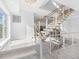 Modern staircase design with wood treads, white risers, and cable railing system at 18077 3Rd St, Redington Shores, FL 33708