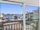 Balcony view showcasing nearby homes, palm trees, and clear blue skies from the property at 18077 3Rd St, Redington Shores, FL 33708