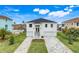 Stunning two-story white home featuring a double garage and landscaped front yard at 3431 Palometa Dr, Hernando Beach, FL 34607