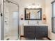 Modern bathroom with a glass-enclosed shower and a double sink vanity with gray cabinets at 5927 3Rd N Ave, St Petersburg, FL 33710