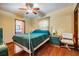 Bedroom featuring hardwood floors, ceiling fan, and a full-sized bed at 5927 3Rd N Ave, St Petersburg, FL 33710