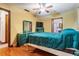 Bedroom with wood floors, ceiling fan, turquoise bedspread, and coordinating turquoise furniture at 5927 3Rd N Ave, St Petersburg, FL 33710