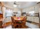 Eat-in kitchen with wooden dining table, wood floors, and white cabinets at 5927 3Rd N Ave, St Petersburg, FL 33710