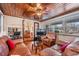 Spacious living room with wood panel ceiling, hardwood floors, and a big sofa at 5927 3Rd N Ave, St Petersburg, FL 33710