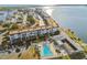 Aerial view of condominium complex featuring a swimming pool and water views at 7 Elgin Pl # 603, Dunedin, FL 34698