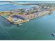 Aerial view of waterfront community with a pool, tennis courts, private dock and stunning blue waters at 7 Elgin Pl # 603, Dunedin, FL 34698