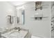 Bathroom featuring a stone vanity, glass shelves and modern lighting at 7 Elgin Pl # 603, Dunedin, FL 34698