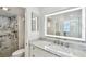 Gorgeous, updated bathroom featuring a marble walk-in shower, granite counters and an LED mirror at 7 Elgin Pl # 603, Dunedin, FL 34698