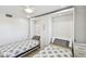 Twin bedroom featuring a ceiling fan, wood-look floors and built in Murphy bed with drawers at 7 Elgin Pl # 603, Dunedin, FL 34698