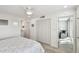 Bright bedroom with wood floors, ceiling fan, closet space and entry to the ensuite sitting area at 7 Elgin Pl # 603, Dunedin, FL 34698