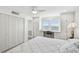 All-white bedroom with a dedicated work space, storage and scenic views of the bay at 7 Elgin Pl # 603, Dunedin, FL 34698