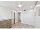 Bright bedroom with white walls, ceiling fan, wood-look floors and built in storage cabinet at 7 Elgin Pl # 603, Dunedin, FL 34698