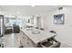 Open floor plan living space with granite countertop kitchen island and amazing waterfront views at 7 Elgin Pl # 603, Dunedin, FL 34698