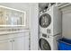 Bathroom with washer, dryer and granite vanity top at 7 Elgin Pl # 603, Dunedin, FL 34698