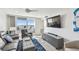 Living room with balcony ocean views and comfortable seating at 7 Elgin Pl # 603, Dunedin, FL 34698