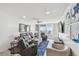 Bright and inviting living room with comfortable seating, a ceiling fan, and balcony access with ocean views at 7 Elgin Pl # 603, Dunedin, FL 34698