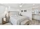 Main bedroom with en suite bath, wood look floors and neutral decor at 7 Elgin Pl # 603, Dunedin, FL 34698