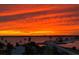 Vibrant sunset over the water, palm trees, and distant city lights provide a stunning backdrop for the property at 7 Elgin Pl # 603, Dunedin, FL 34698