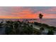 Spectacular sunset view with pink clouds, tropical trees, and the bay at 7 Elgin Pl # 603, Dunedin, FL 34698